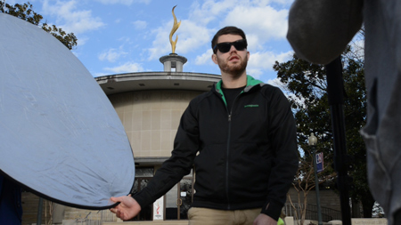 John holding reflector